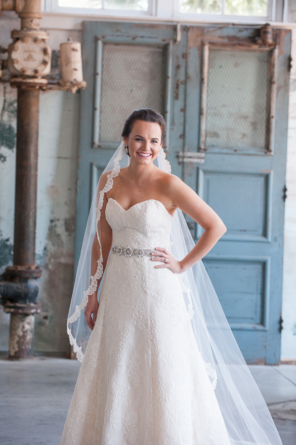 Bridal portraits at 701 Whaley near rustic door with lace veil