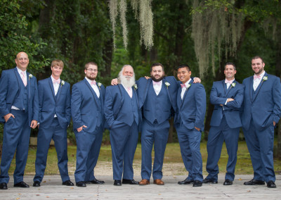 Groomsmen on bridge in blue tuxes at Adam's Pond