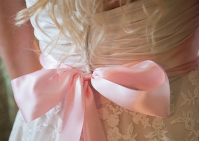 Pink belt on a lace wedding dress