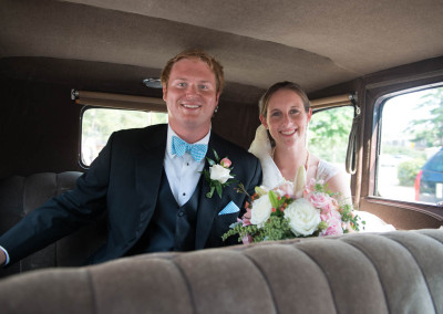 Bride and groom in classic car