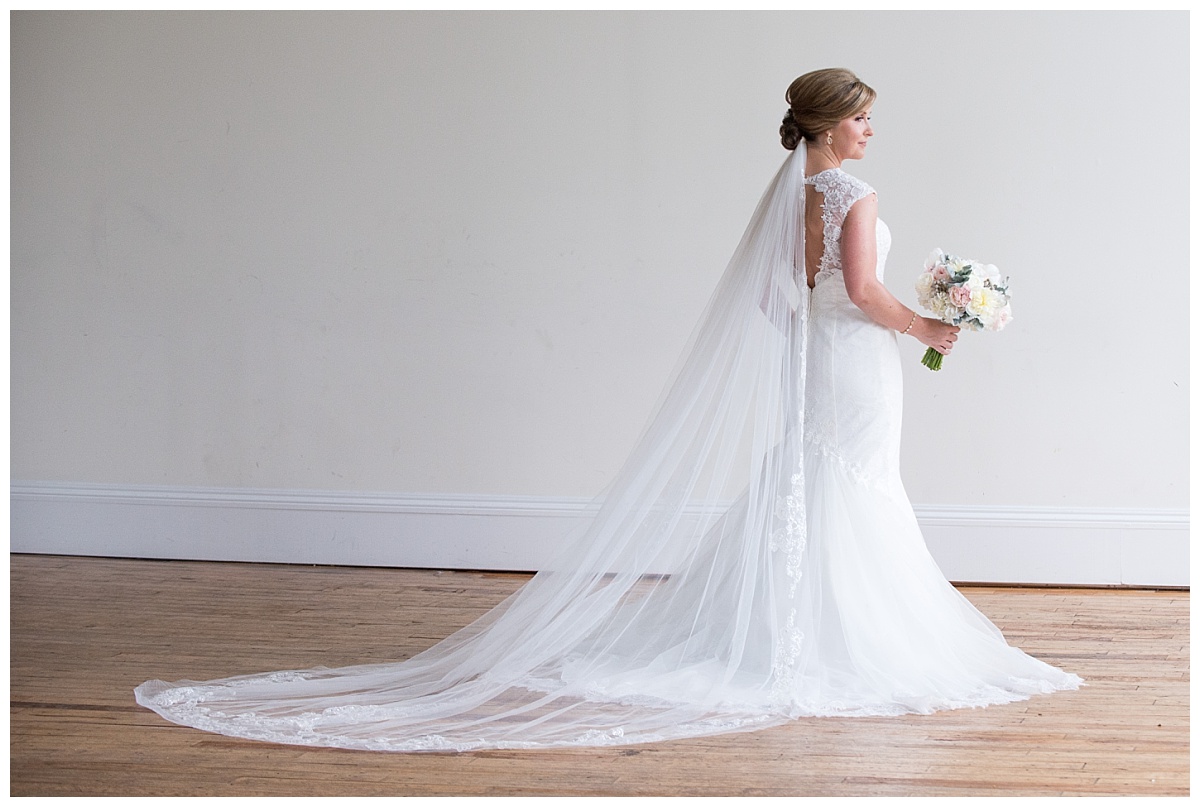 Bride at window photo with long veil