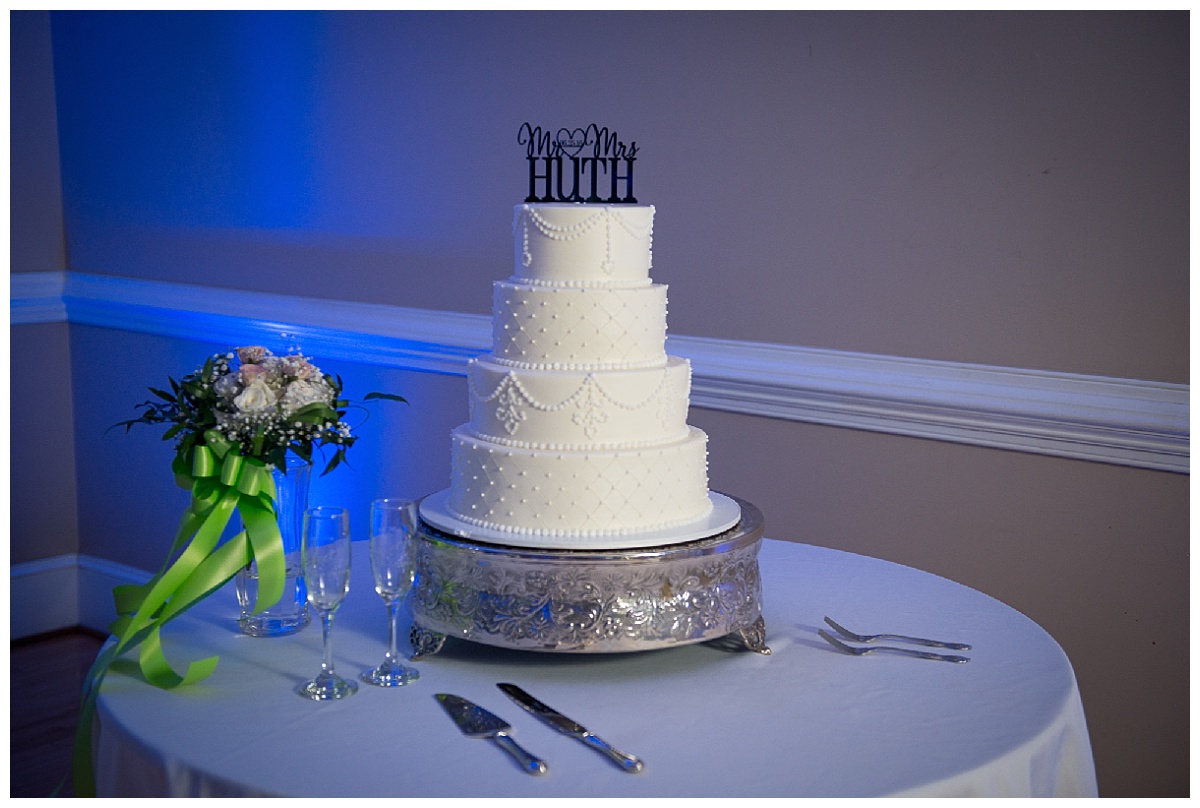 cake with uplighting and custom wedding cake topper