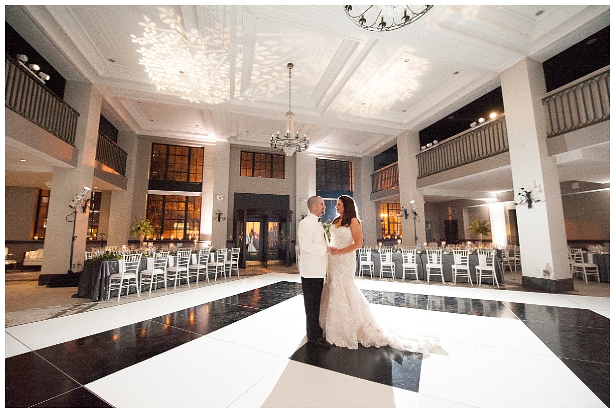 Bride and groom at black and white ballroom reception hall